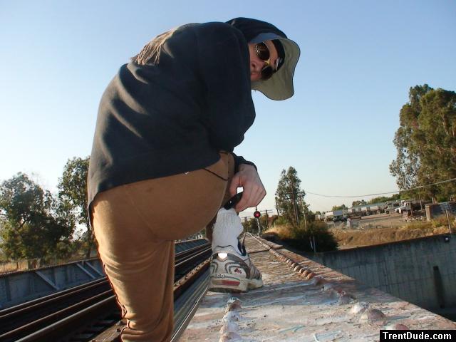 Brown sweats on train trestle (rear), Ascis Gel Evolution 3 shoe (TN7A2), Oregon Research Helios sun hat, Christian Dior Monsieu