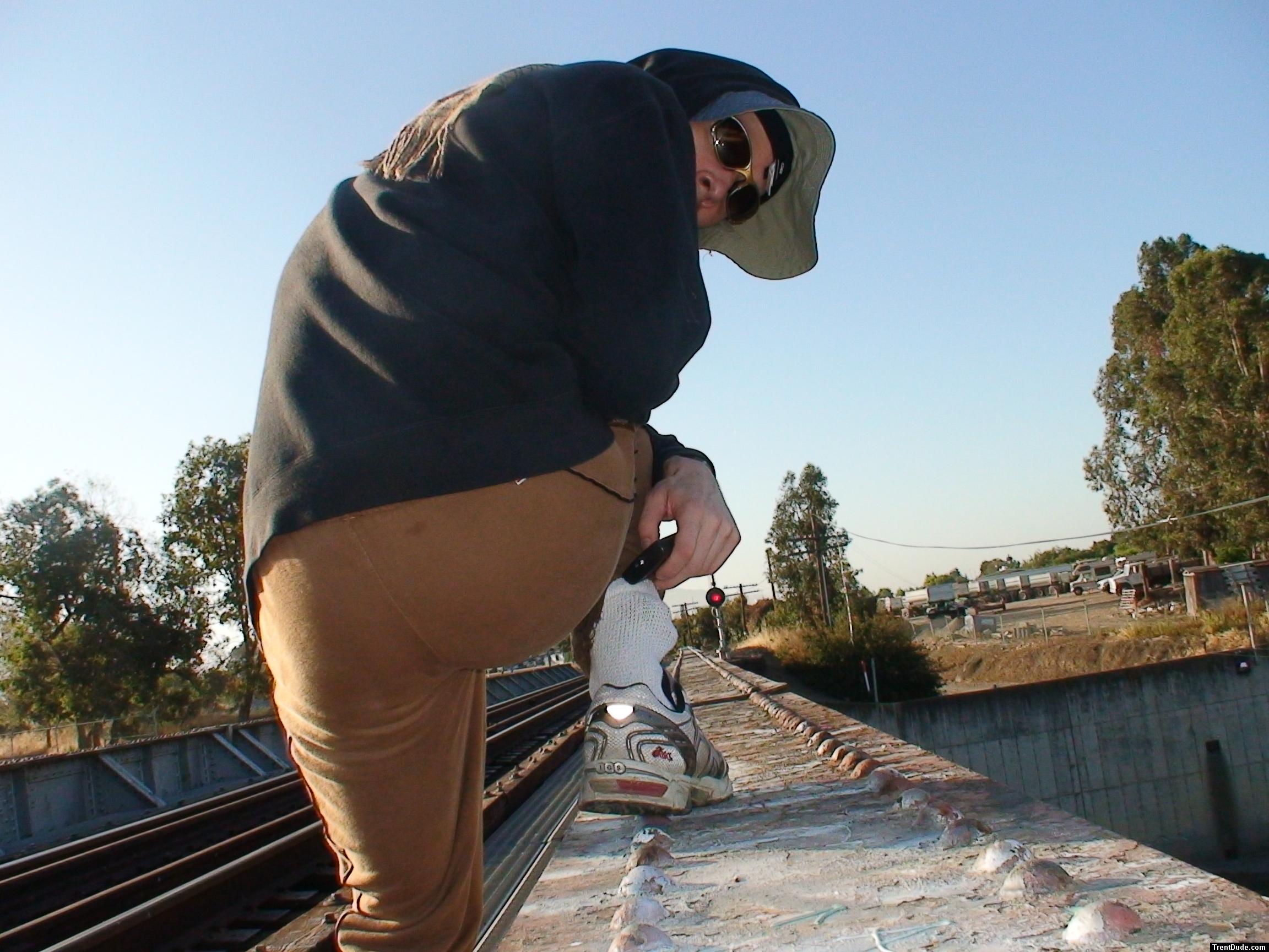 Brown sweats on train trestle (rear), Ascis Gel Evolution 3 shoe (TN7A2), Oregon Research Helios sun hat, Christian Dior Monsieu