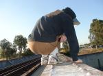 Brown sweats on train trestle (rear), Ascis Gel Evolution 3 shoe (TN7A2), Oregon Research Helios sun hat, Christian Dior Monsieu