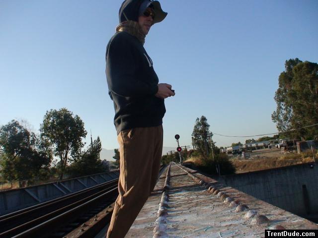 Brown sweats on train trestle, Oregon Research Helios sun hat, Christian Dior Monsieur Cashmere scarf