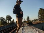 Brown sweats on train trestle, Oregon Research Helios sun hat, Christian Dior Monsieur Cashmere scarf