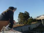 Brown sweats on train trestle (rear), Ascis Gel Evolution 3 shoe (TN7A2), watching BART train