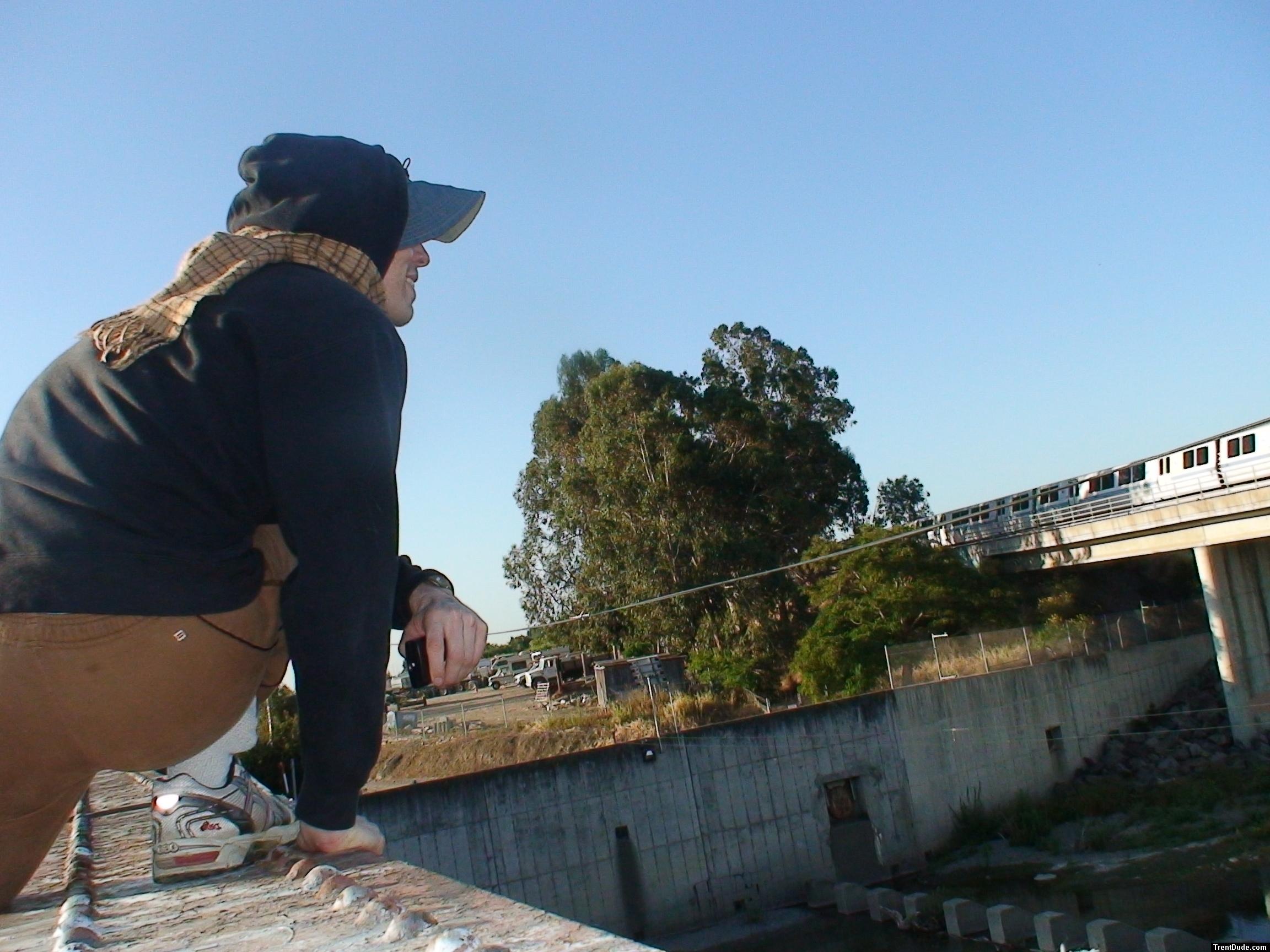 Brown sweats on train trestle (rear), Ascis Gel Evolution 3 shoe (TN7A2), Oregon Research Helios sun hat, Christian Dior Monsieu