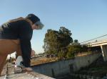 Brown sweats on train trestle (rear), Ascis Gel Evolution 3 shoe (TN7A2), Oregon Research Helios sun hat, Christian Dior Monsieu