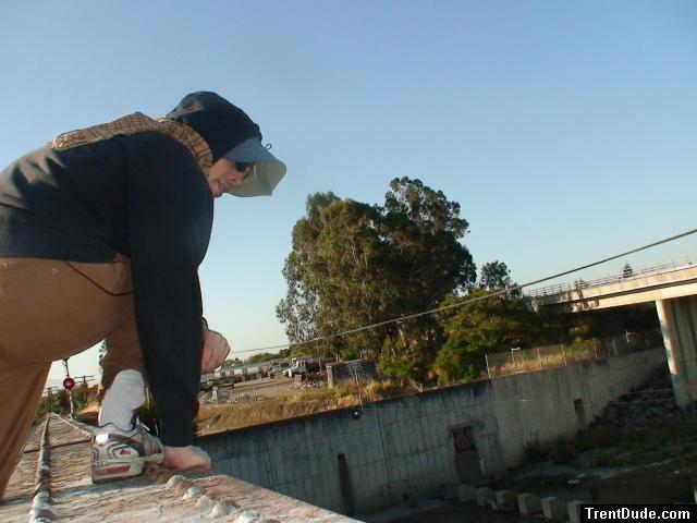 Brown sweats on train trestle (rear), Ascis Gel Evolution 3 shoe (TN7A2), Oregon Research Helios sun hat, Christian Dior Monsieu