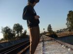 Brown sweats on train trestle, Oregon Research Helios sun hat, Christian Dior Monsieur Cashmere scarf