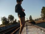 Brown sweats on train trestle, Oregon Research Helios sun hat, Christian Dior Monsieur Cashmere scarf
