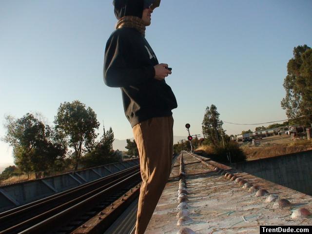 Brown sweats on train trestle, Oregon Research Helios sun hat, Christian Dior Monsieur Cashmere scarf