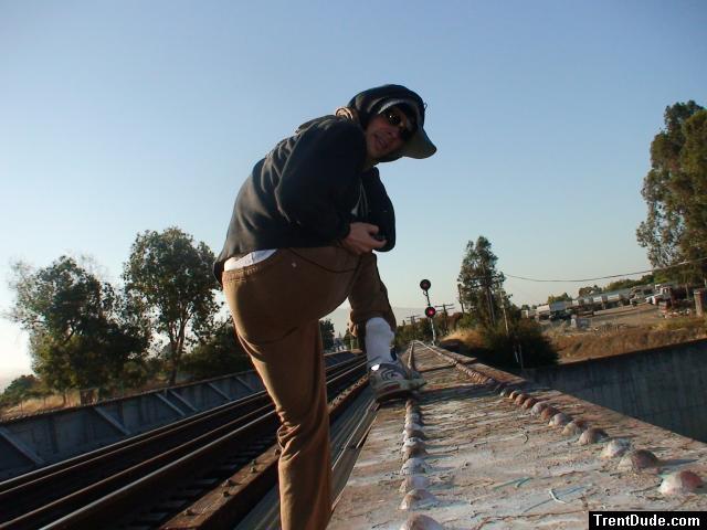 Brown sweats on train trestle (rear), Ascis Gel Evolution 3 shoe (TN7A2), Oregon Research Helios sun hat, Christian Dior Monsieu