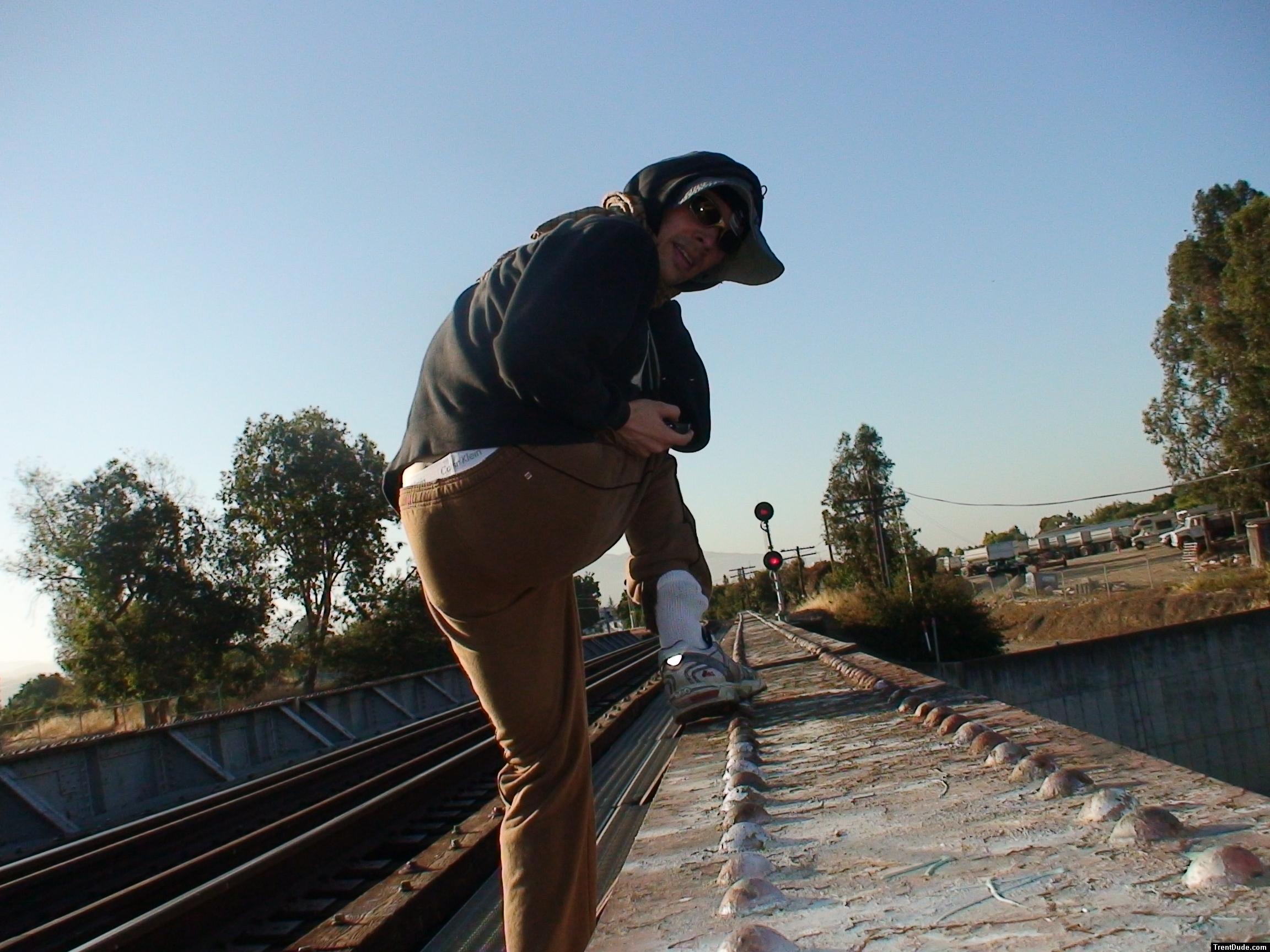 Brown sweats on train trestle (rear), Ascis Gel Evolution 3 shoe (TN7A2), Oregon Research Helios sun hat, Christian Dior Monsieu