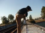 Brown sweats on train trestle (rear), Ascis Gel Evolution 3 shoe (TN7A2), Oregon Research Helios sun hat, Christian Dior Monsieu