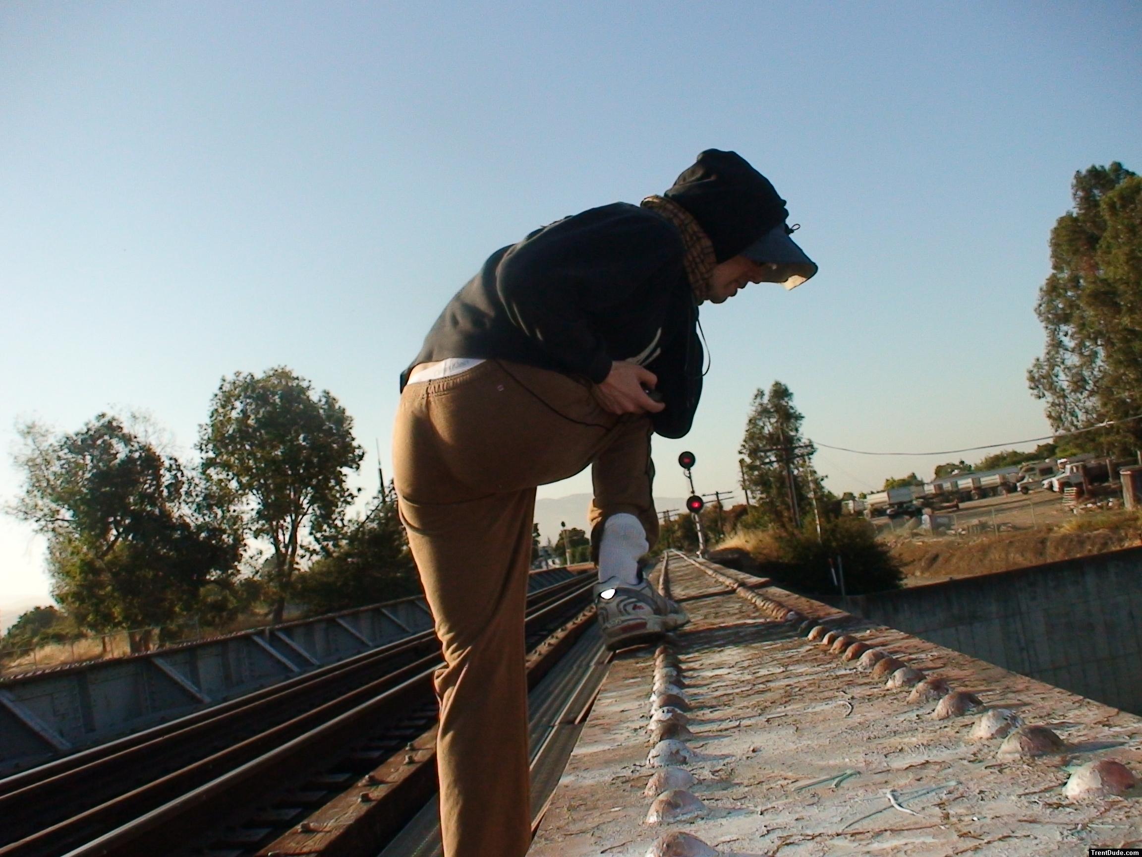 Brown sweats on train trestle (rear), Ascis Gel Evolution 3 shoe (TN7A2), Oregon Research Helios sun hat, Christian Dior Monsieu
