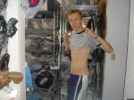 Lifting up shirt, showing abs and basketball shorts