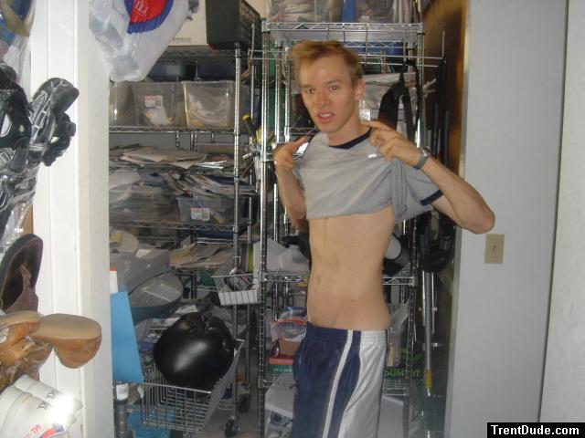 Lifting up shirt, showing abs and basketball shorts