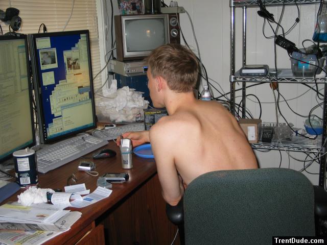 back, sitting in a chair at the computer