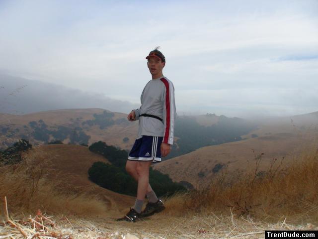 Photoshoot 23 on a mountain top wearubg Blue Addidas shorts, Reebok long sleve shirt