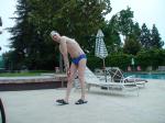 Blue Nike speedo, white swim cap (stretching)