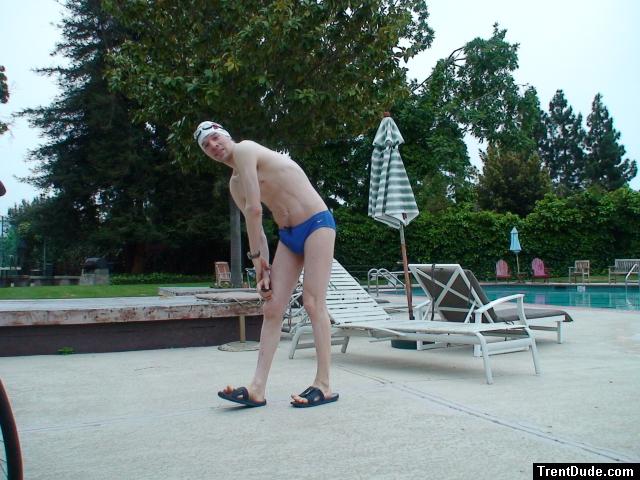 Blue Nike speedo, white swim cap (stretching)