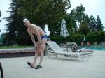 Blue Nike speedo, white swim cap (stretching)
