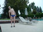 Blue Nike speedo, white swim cap (stretching)