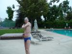 Blue Nike speedo, white swim cap (stretching)
