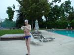 Blue Nike speedo, white swim cap (holding peanuts for the birds)