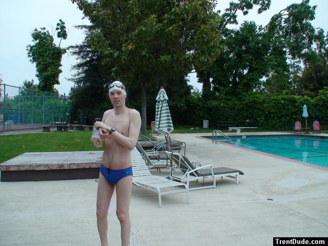Blue Nike speedo, white swim cap (holding peanuts for the birds)
