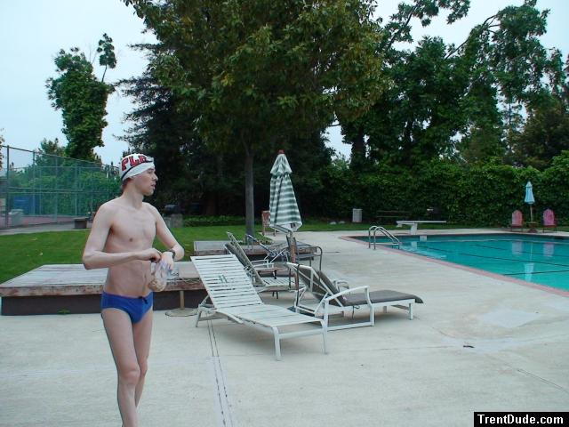 Blue Nike speedo, white swim cap (holding peanuts for the birds)
