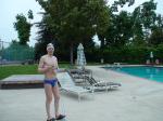 Blue Nike speedo, white swim cap (holding peanuts for the birds)