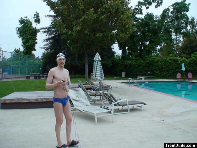 Blue Nike speedo, white swim cap (holding peanuts for the birds)