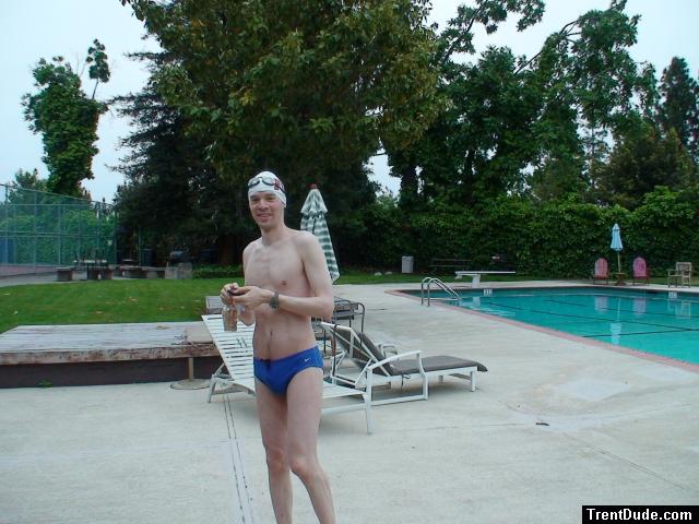 Blue Nike speedo, white swim cap (holding peanuts for the birds)