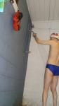 Blue Nike speedo, white swim cap (rear)