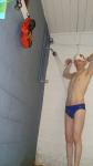 Blue Nike speedo, white swim cap (arm pits)