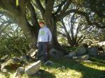 Trent by a secret tree (a favorite spot of his on the ranch), wearing a John Deere sweatshirt and Addidas nylon pants (for sale)
