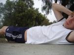 doing situps on the cement in a park