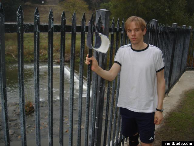 Dude wearing a t-shirt outside by a creek