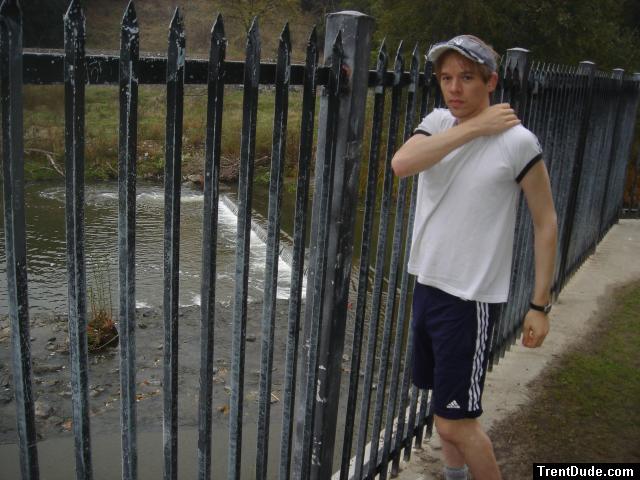 Doing some stretches in the morning outside by a creek.  Addidas shorts with pockets.