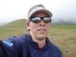 Trent outside on a hill in Ray Ban sunglasses, Yankees cap, and Rams shirt (for sale).  You can see his hand in the reflection.