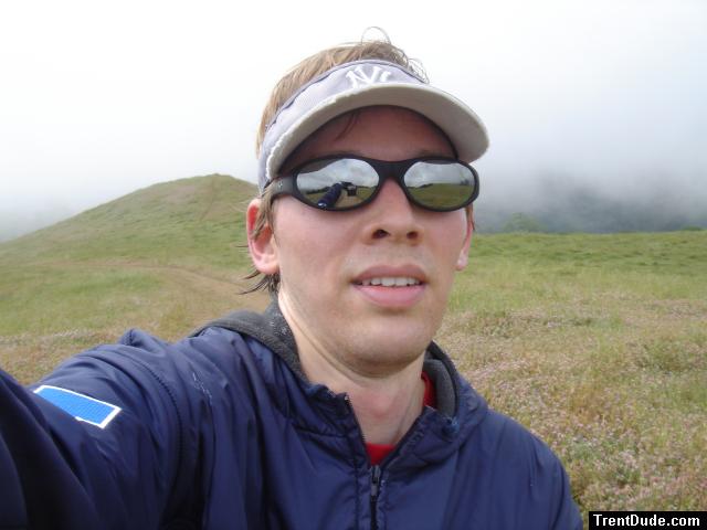 Trent outside on a hill in Ray Ban sunglasses, Yankees cap, and Rams shirt (for sale).  You can see his hand in the reflection.