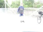 Trent on a bridge with bike wearing a Rams sweatshirt (for sale) and blue nylon shorts. Maybe its time to use adobe.