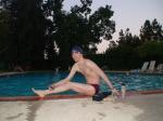 Red Speedo Aquablade swim brief, poolside stretching