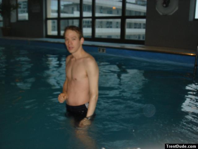 Trent in a pool with building in the background