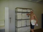 Nike swim jammer in the swim locker room, near some towels, drinking fruit smooothie before a swim