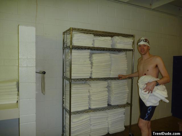 Nike swim jammer in the swim locker room, near some towels,
