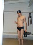 Standing in the swim locker room in a Nike black/blue swim brief