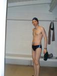 Standing in the swim locker room in a Nike black/blue swim brief