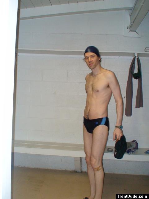 Standing in the swim locker room in a Nike black/blue swim brief