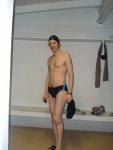 Standing in the swim locker room in a Nike black/blue swim brief