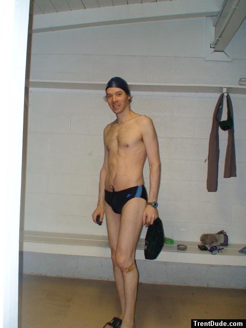 Standing in the swim locker room in a Nike black/blue swim brief