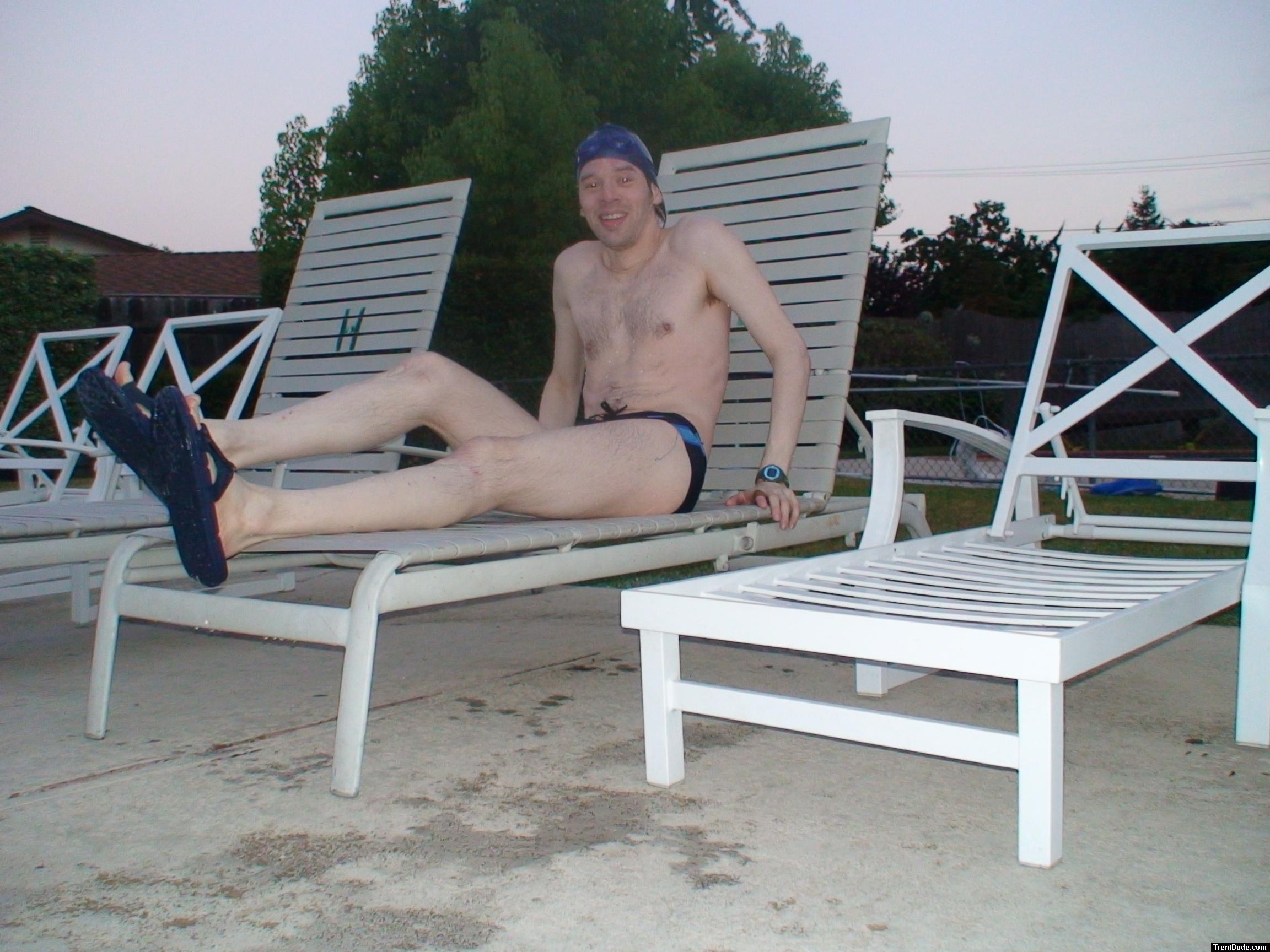 Relaxing in a deck chair at the pool after a long swim